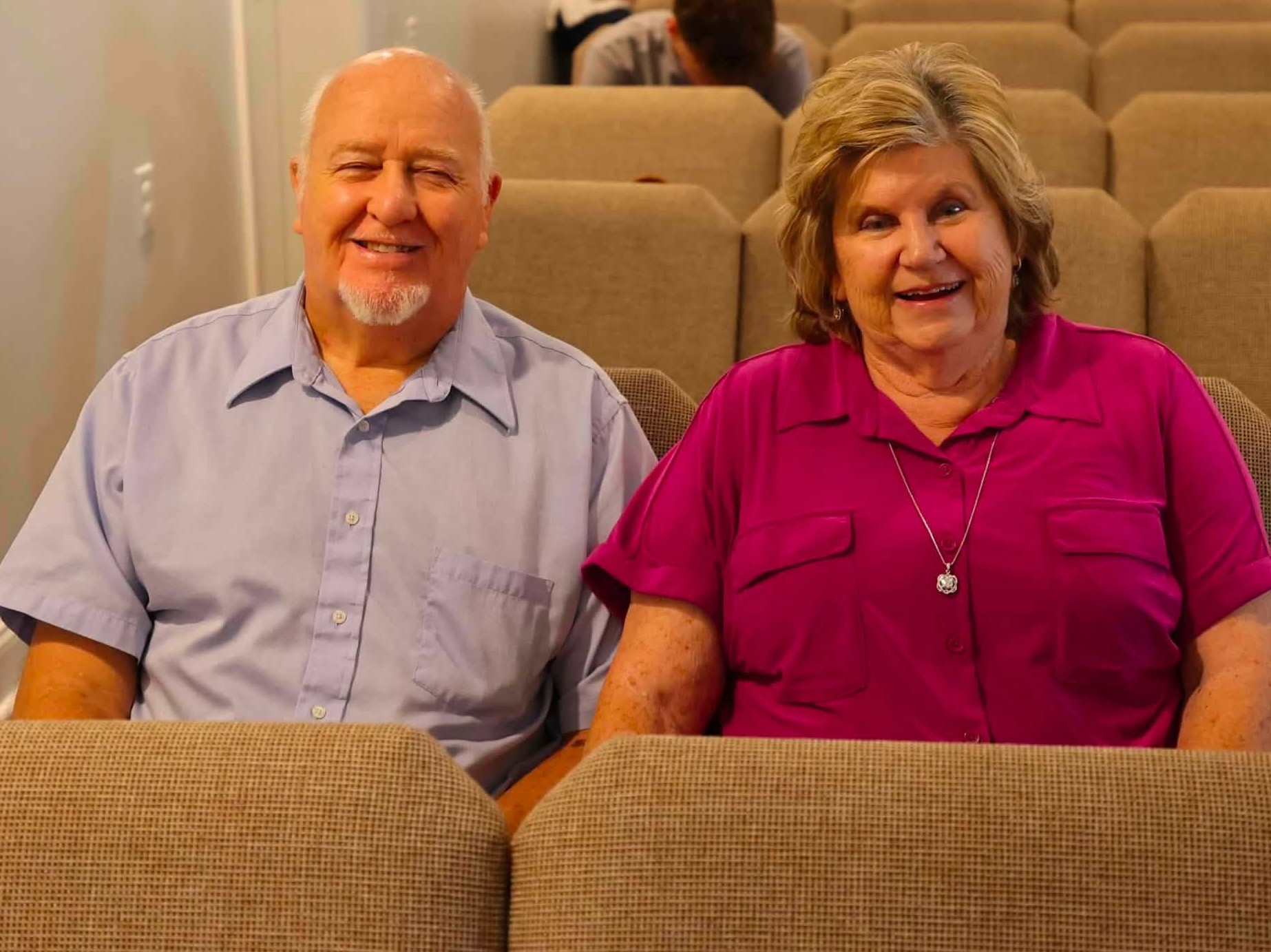 Two New Vision Church members smiling together in the sanctuary